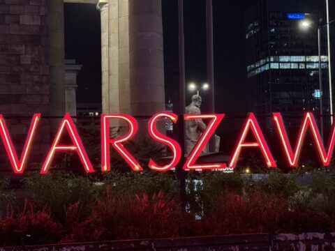 A picture of the neon Warszawa sign at The Palace of Science and Culture in Warsaw, Poland