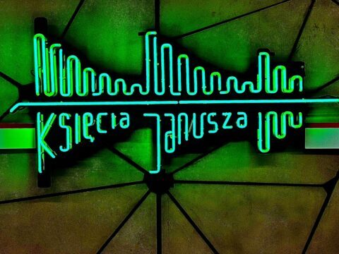 A picture of the neon metro sign on the platform at Ksiecia Janusza metro station in Warsaw, Poland