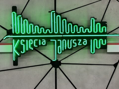 A picture of the neon metro sign on the platform at Ksiecia Janusza metro station in Warsaw, Poland