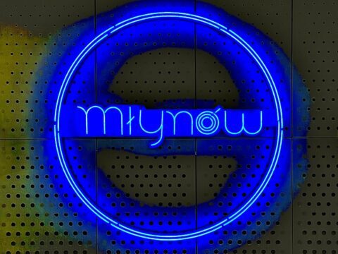 A picture of the neon metro sign on the platform at Mlynow metro station in Warsaw, Poland