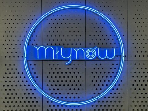 A picture of the neon metro sign on the platform at Mlynow metro station in Warsaw, Poland