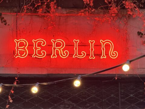 A picture of the neon Berlin sign on a building in Warsaw, Poland